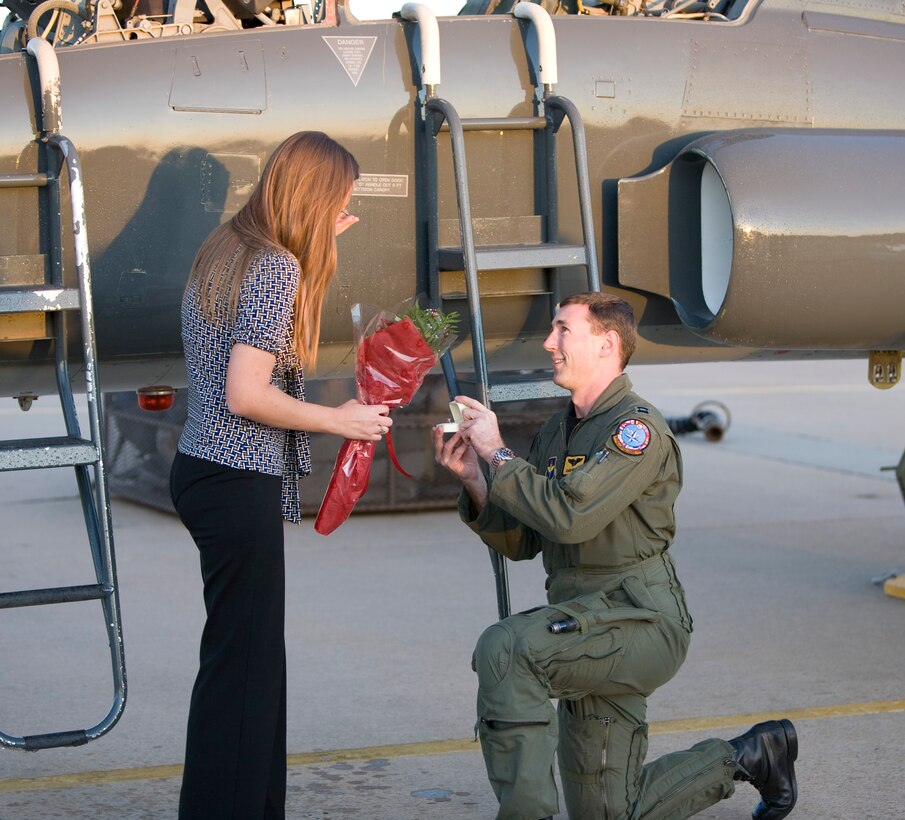 Captain Curtis Weddle, 90th Flying Training Squadron assistant flight commander and T-38 undergraduate pilot training instructor pilot, proposes to his girlfriend Monica Morris after the fini Flight of Captain Tony Hebert, 90th FTS commander’s special assistant and T-38 undergraduate pilot training instructor pilot, Nov. 23. (U.S. Air Force Photo/ Lt. Col. Ternell Washington)