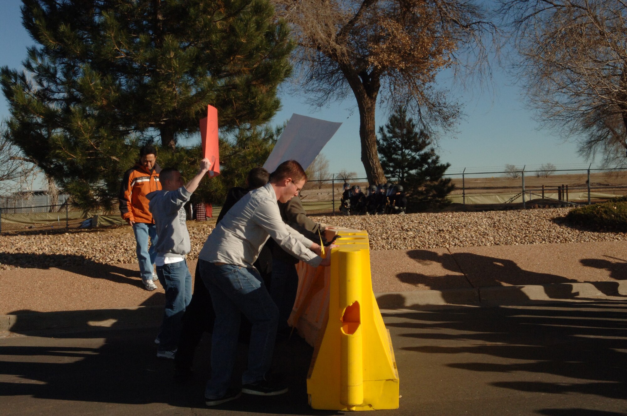 BUCKLEY AIR FORCE BASE, Colo. -- Volunteer mock protesters challenge barriers during an exercise Nov. 24. (U. S. Air Force photo by Tech. Sgt Shirley Henderson)