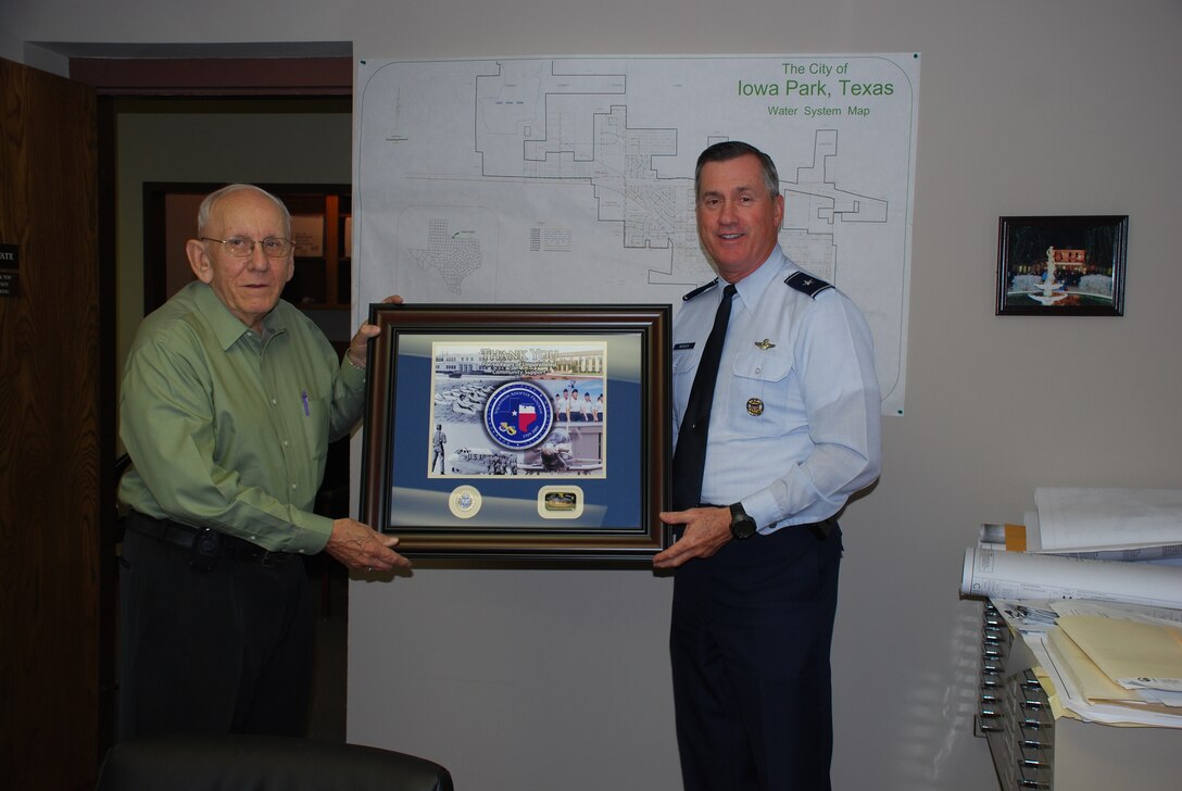 Joe Ward, Iowa Park, Texas mayor, receives a Squadron Adopter Program 50th Anniversary momento from 82nd Training Wing Commander Brig. Gen. O.G. Mannon for the city's support of the program. (U.S. Air Force photo/Airman 1st Class Valerie Hosea) 