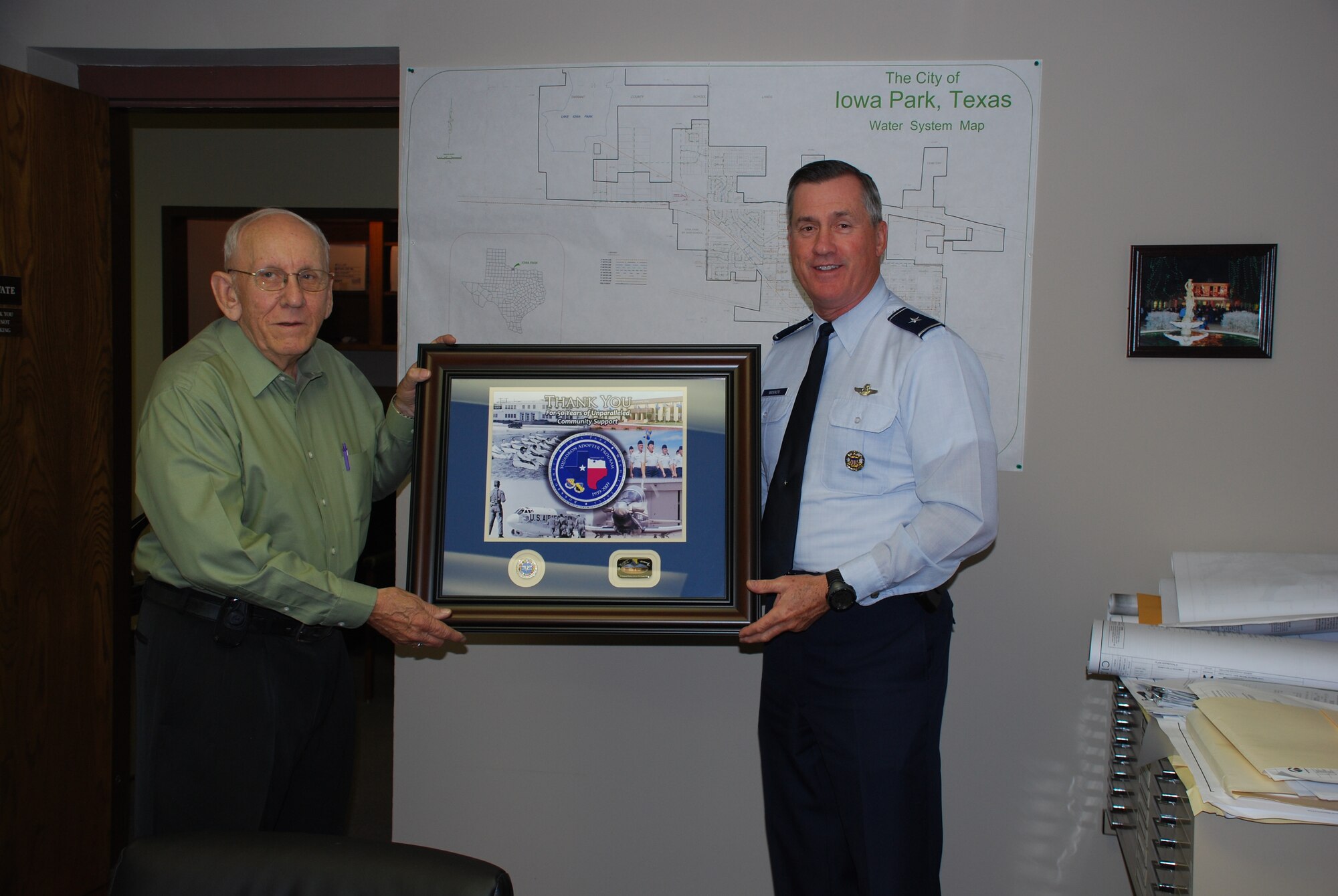 Joe Ward, Iowa Park, Texas mayor, receives a Squadron Adopter Program 50th Anniversary momento from 82nd Training Wing Commander Brig. Gen. O.G. Mannon for the city's support of the program. (U.S. Air Force photo/Airman 1st Class Valerie Hosea) 