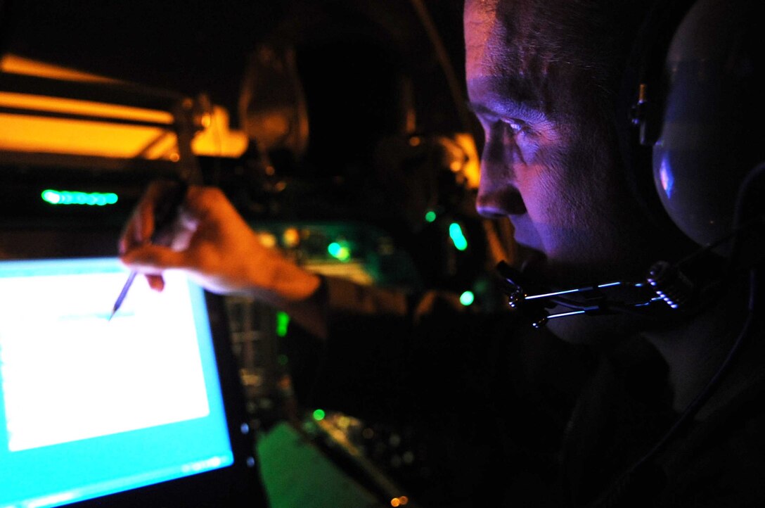 ELLSWORTH AIR FORCE BASE, S.D.--Maj. Chris Lovegren, 34th Bomb Squadron pilot, operates the Beyond Line Of Sight system of a B-1B Lancer during his pre-flight checklist Nov. 23. The BLOS system is capable of providing a variety of information including high-resolution terrain mapping. (U.S. Air Force photo/Airman 1st Class Corey Hook)