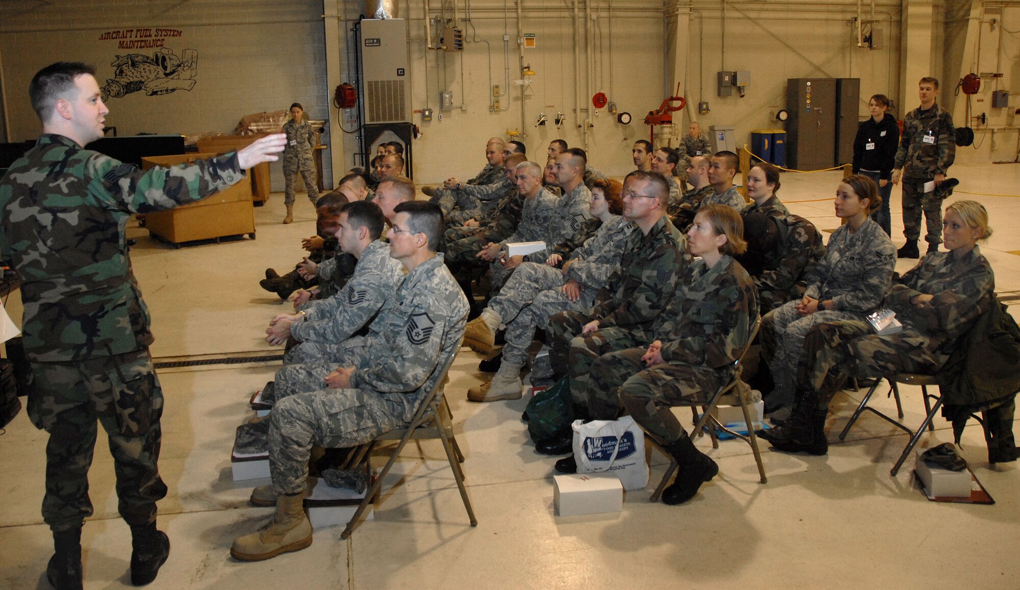 Staff Sgt. Ken Gordon gives a pre-deployment brief to deploying members at the 110th Fighter Wing, Battle Creek, Mi., Nov. 7, 2009. Gordon was participating in a mobility training exercise at the base. (U.S. Air Force photo by Tech. Sgt. David Eichaker/released)