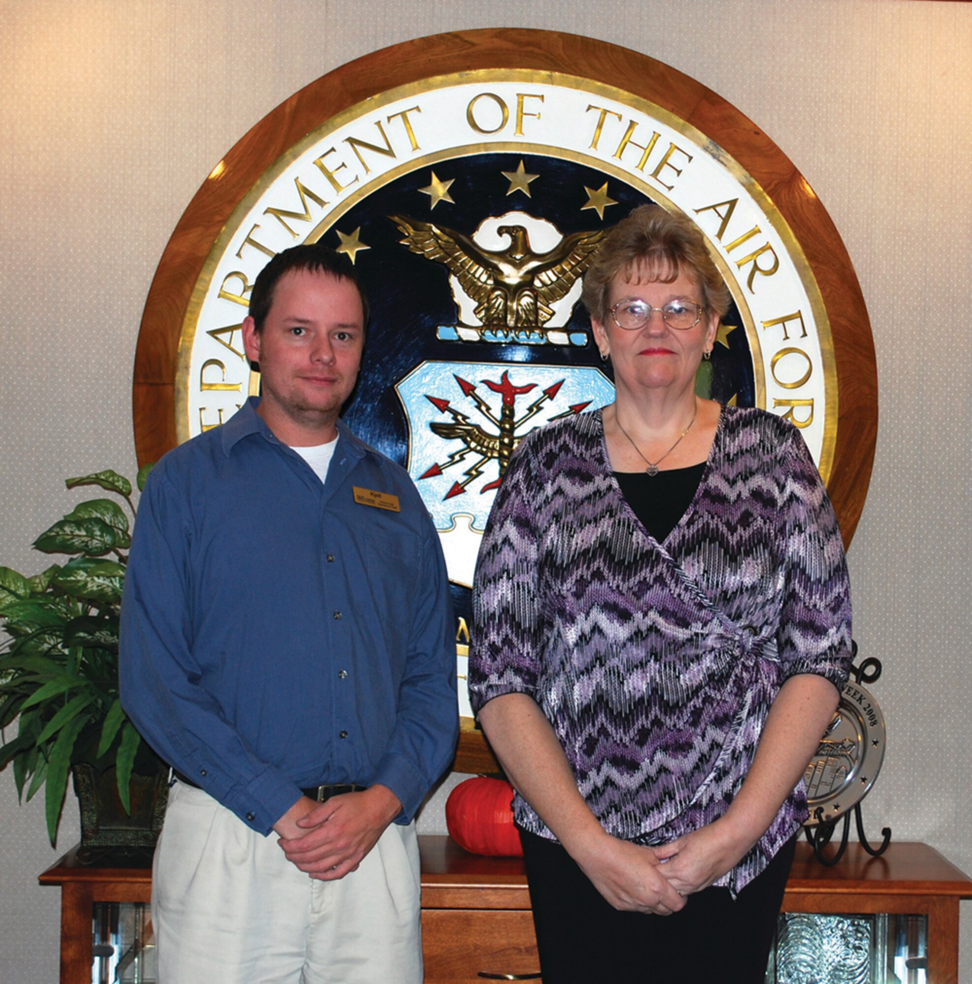 OFFUTT AIR FORCE BASE, Neb. - Kjell Flatoen, acting Patriot Club manager (left) and Cathy L. Francis, the wife of retired Master Sgt. Mitchell J. Francis (right), pose for a photo at the Patriot Club shortly after Mrs. Francis was notified that her essay, "The High Cost of Freedom," was one of 25 winning essays selected in the Air Force's 2009 Membership Scholarship Program essay contest. The contest awarded 25 $1,000 scholarships to Air Force family club members. U.S. Air Force Courtesy Photo