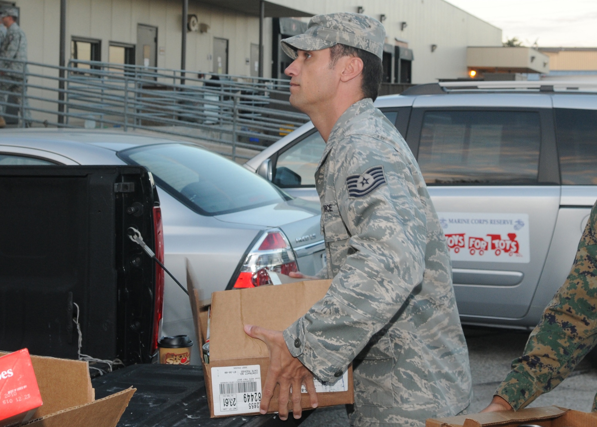 GOODFELLOW AIR FORCE BASE, Texas -- Tech. Sgt. Robert Hempel, 17th Training Wing public affairs, helps load a truck with Warmheart baskets, Nov. 24, 2009. Operation Warmheart is a year-round program to assist servicemembers and their families by providing food, clothes, toys, and in some cases funds for those in need. The program is managed by the First Sergeants Council and supported by volunteers from the base and community. (U.S. Air Force photo/Airman Clayton Lenhardt)
