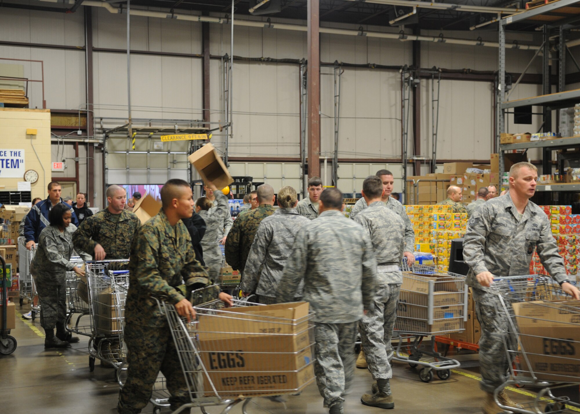 GOODFELLOW AIR FORCE BASE, Texas -- Volunteers for Operation Warmheart load boxes with food as they go through the line at the commissary warehouse, Nov. 24, 2009.  Operation Warmheart is a year-round program to assist servicemembers and their families by providing food, clothes, toys, and in some cases funds for those in need. The program is managed by the First Sergeants Council and supported by volunteers from the base and community. (U.S. Air Force photo/Airman Clayton Lenhardt)