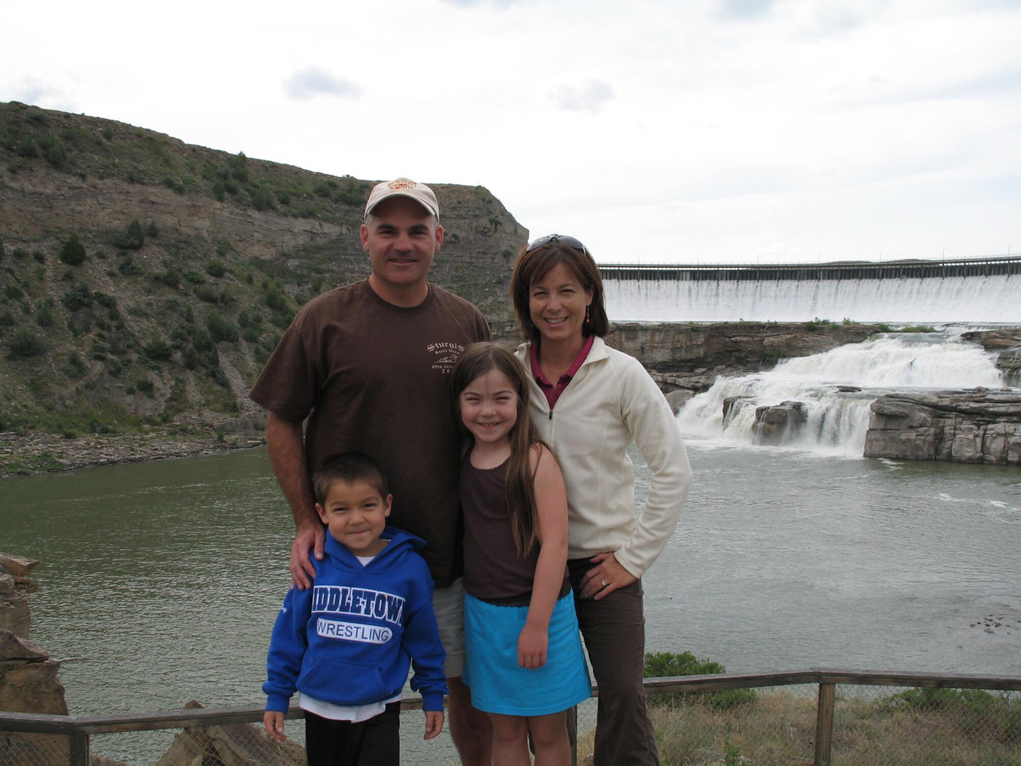 Lt. Cols. Gregory and Linda Rosenmerkel and their children Allison and Raymond pose for a picture with the Black Eagle Dam and Falls in the background. (Courtesy photo)