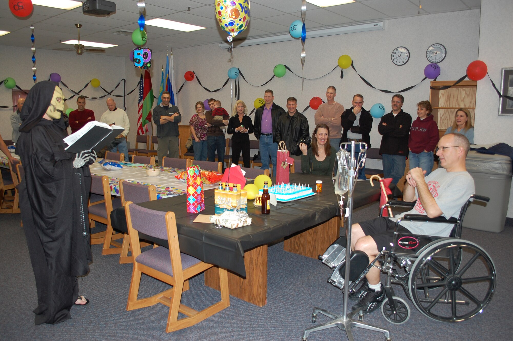 Family and friends of Col. Michael Fortney threw him a surprise 50th birthday party Nov. 22. The Grim Reaper took center stage reading a story of death and turned out to be the biggest surprise of all when the mask came off. Colonel Fortney's older sister, Cindy Reaster, who shares the same birthday with him, came to town to celebrate with her brother. Colonel Fortney is the 341st Missile Wing commander. (U.S. Air Force photo/2nd Lt. Marshel Slater)