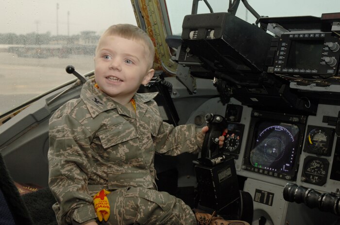 Samuel Jones sits in the pilot seat of a C-17 during his recent tour here Nov. 24. Samuel was diagnosed with cystic fibrosis at birth and was chosen to be honored through the Pilot for a Day program by Charleston AFB leadership. Samuel is the son of retired Master Sgt. Ronald and Mariah Jones. (U.S. Air Force photo/Staff Sgt. Marie Brown)