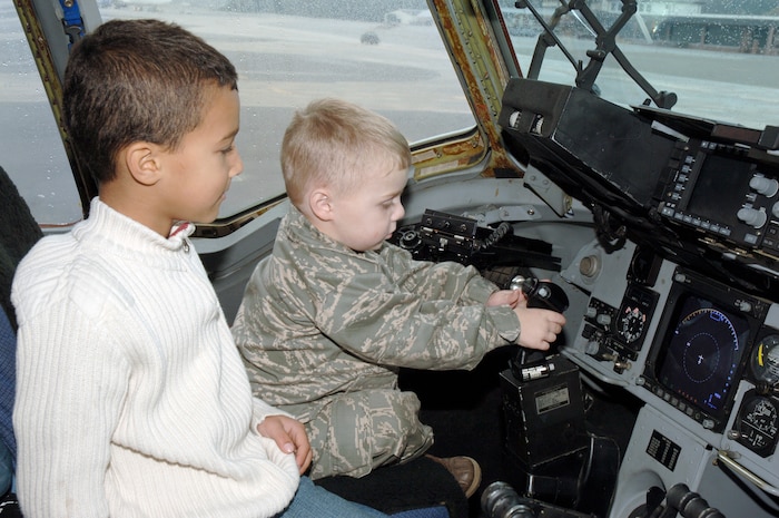 Samuel Jones, right, and Nicholas Campbell sit in the pilot seat of a C-17 during their recent tour here through the Pilot for a Day program Nov. 24.  The base works in conjunction with the South Carolina Make-a-Wish Foundation, the Medical University of South Carolina and the Charleston AFB medical clinic to identify children eligible to participate in the program. Samuel was diagnosed with cystic fibrosis at birth and is the son of retired Master Sgt. Ronald and Mariah Jones and Nicholas is his step-brother. (U.S. Air Force photo/Staff Sgt. Marie Brown)