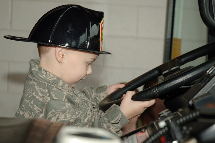 Samuel Jones sits in the seat of a Charleston AFB fire truck during his recent tour here Nov. 24. Charleston AFB leadership honored Samuel through the Pilot for a Day program, a program which aims to bring joy to the lives of critically ill children, as part of the Year of the Air Force Family. Samuel is the son of retired Master Sgt. Ronald and Mariah Jones. (U.S. Air Force photo/Staff Sgt. Marie Brown)