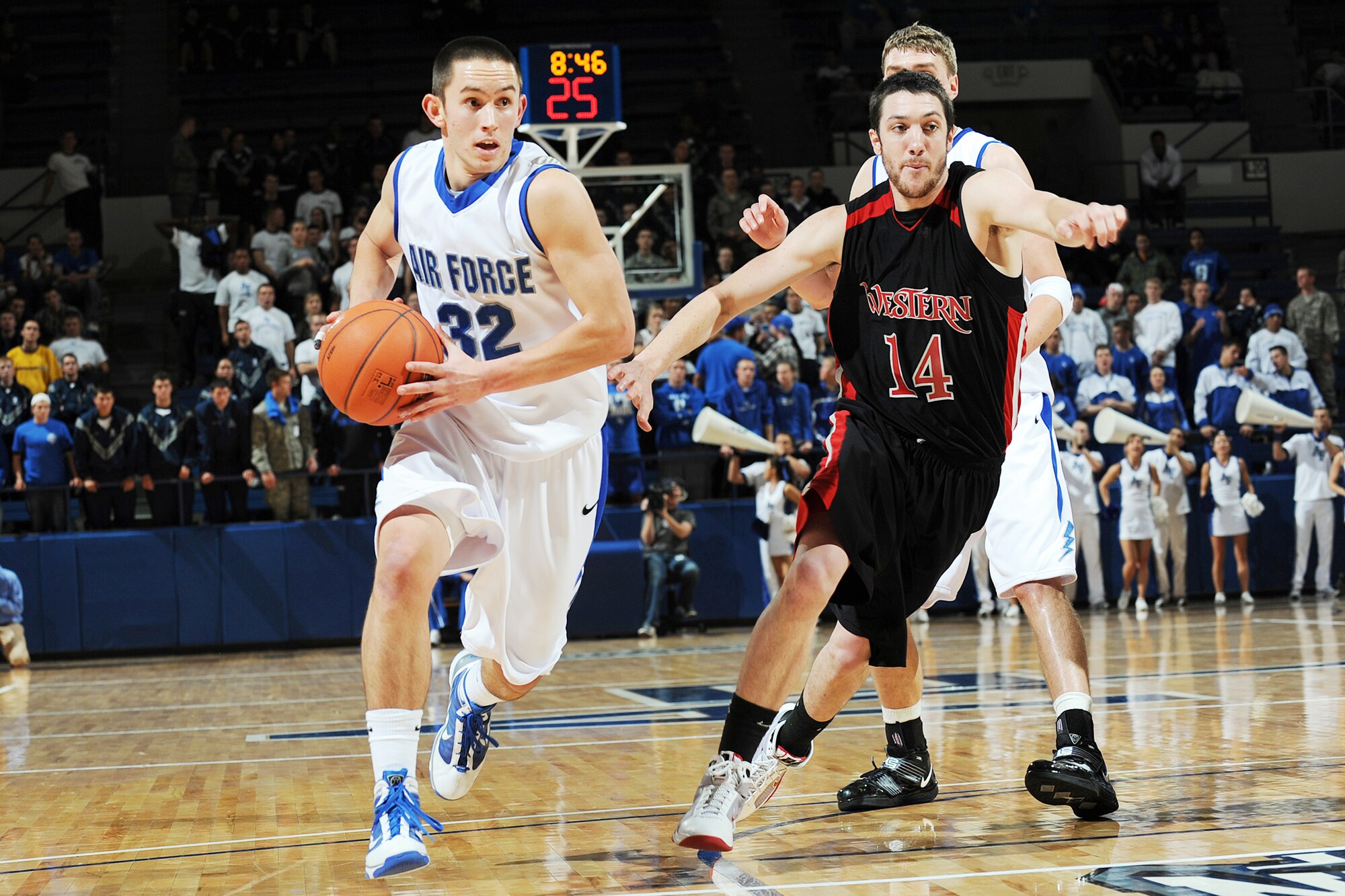 U.S. Air Force Academy Falcon sophomore guard Shawn Hempsey drives the lane while Western States Lachlan Kirwan defends during the Falcon season opener in Clune Arena at the Academy near Colorado Springs, Colo., Nov. 13, 2009.  (U.S. Air Force photo/Rachel Boettcher)