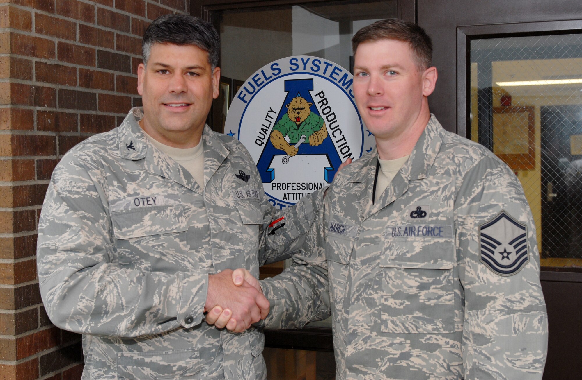 Col. Greg Otey, 19th Airlift Wing commander, presents a commander's coin to Master Sgt. William March, 19th Component Maintenance Squadron production superintendent, for his selection as the Combat Airlifter of the Week. Sergeant March leads and direct the efforts of 273 maintainers in providing aircraft, fuels, hydraulics, electro-environmental, and propulsion systems maintenance. He coordinated 2,500 scheduled and unscheduled maintenance repairs for the 95 aircraft assigned to the 19th, 314th, and 189th Airlift Wings. (U.S. Air Force photo by Senior Airman Nathan Allen)