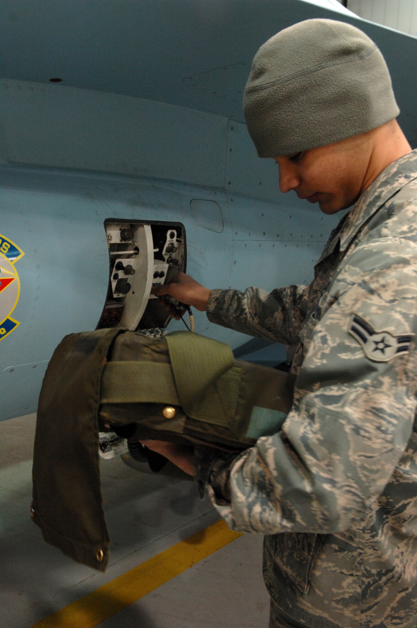 Airman 1st Class Blake Richardson performs an engine check on an F-16 Fighting Falcon Nov. 23, 2009, Eielson Air Force Base, Alaska. Airmen inspect every aircraft before and after every flight to ensure safety. Airman Richardson is a jet engine mechanic assigned to the 18th Aircraft Maintenance Unit. (U.S. Air Force photo/ Airman 1st Class Rachelle Coleman)