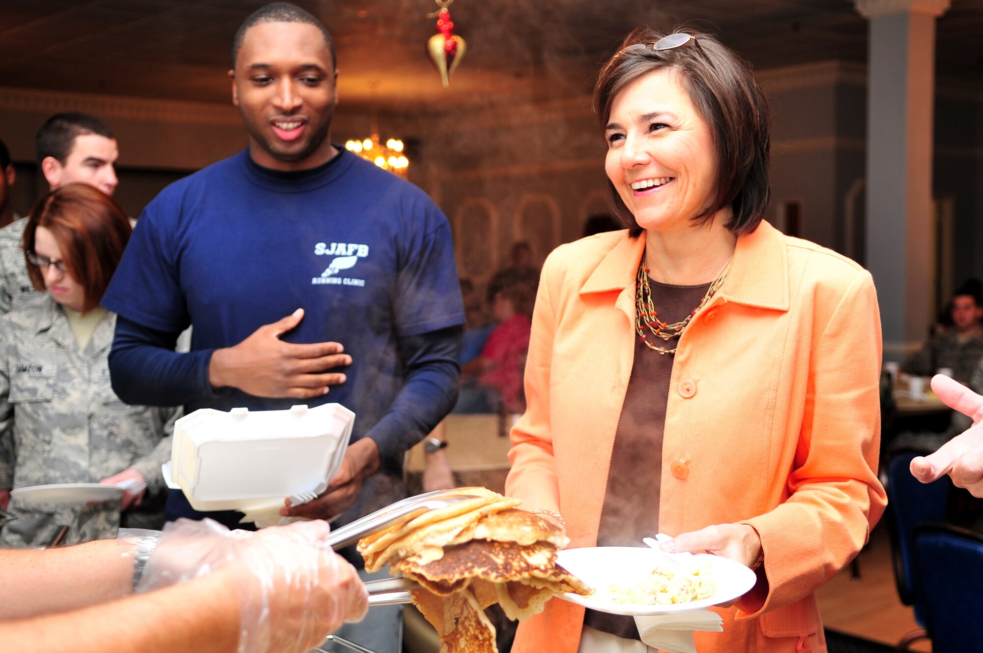 Tanya Kelly, wife of Col. Mark Kelly, 4th Fighter Wing commander, is served a stack of pancakes during a Chief's Pancake Breakfast on Seymour Johnson Air Force Base, N.C., Nov. 20, 2009. Along with pancakes, the base's chiefs served crepes, muffins, scrambled eggs with and without sausage, coffee, milk and juice. (U.S. Air Force photo/Airman 1st Class Rae Perry)