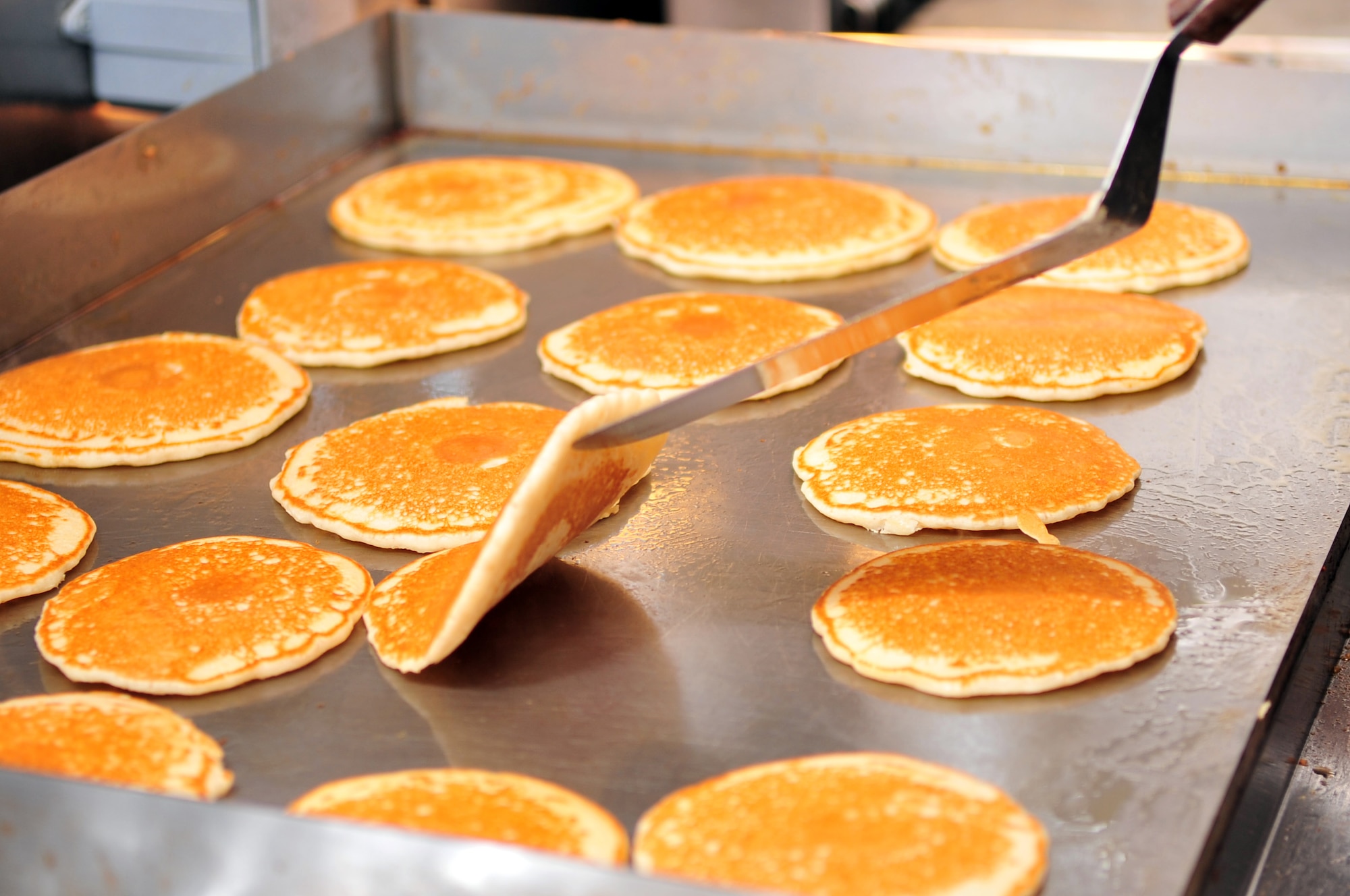 Golden brown pancakes cook on a grill during a Chief's Pancake Breakfast on Seymour Johnson Air Force Base, N.C., Nov. 20, 2009.  The Chief's Group often holds fundraisers to support activities on base for enlisted Airmen. (U.S. Air Force photo/Airman 1st Class Rae Perry)