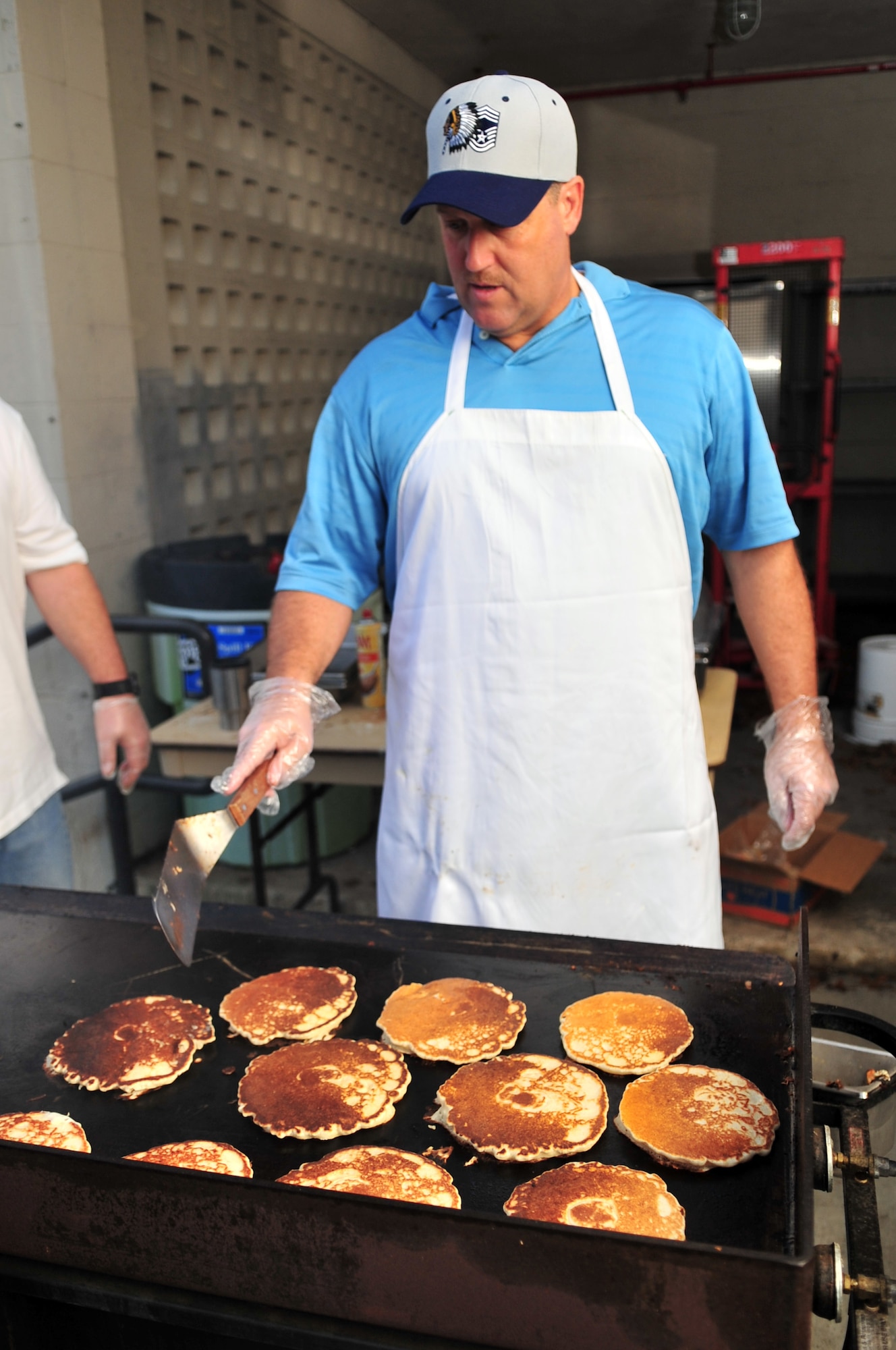 Senior Master Sgt. Brian Gilbert, 4th Maintenance Group chief, prepares pancakes for the Chief's Pancake Breakfast on Seymour Johnson Air Force Base, N.C., Nov. 20, 2009. Sergeant Gilbert was recently selected for promotion to Chief Master Sergeant. The entry fee of $5 covered all the pancakes, eggs and crepes a diner could eat. (U.S. Air Force photo/Airman 1st Class Rae Perry)
