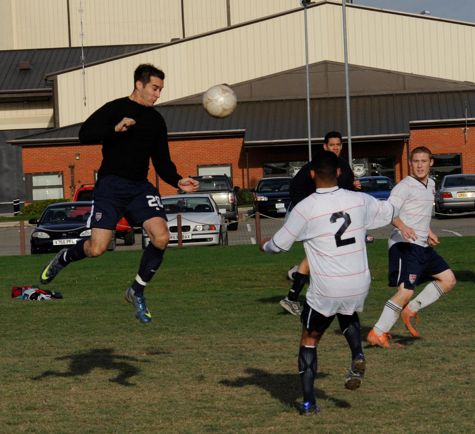 Daniel Acosta, 488th Intelligence Squadron/95th Reconnaissance Squadron, heads the ball goalwards during the intramural soccer championship game against the 100th Logistics Readiness Squadron at the Hardstand Fitness Center Nov. 19. The 488th IS/95th RS, playing their third game of the week, ran out of steam as LRS won the game 2-0 with a goal in each half. (U.S. Air Force photo/Staff Sgt. Christopher L. Ingersoll)