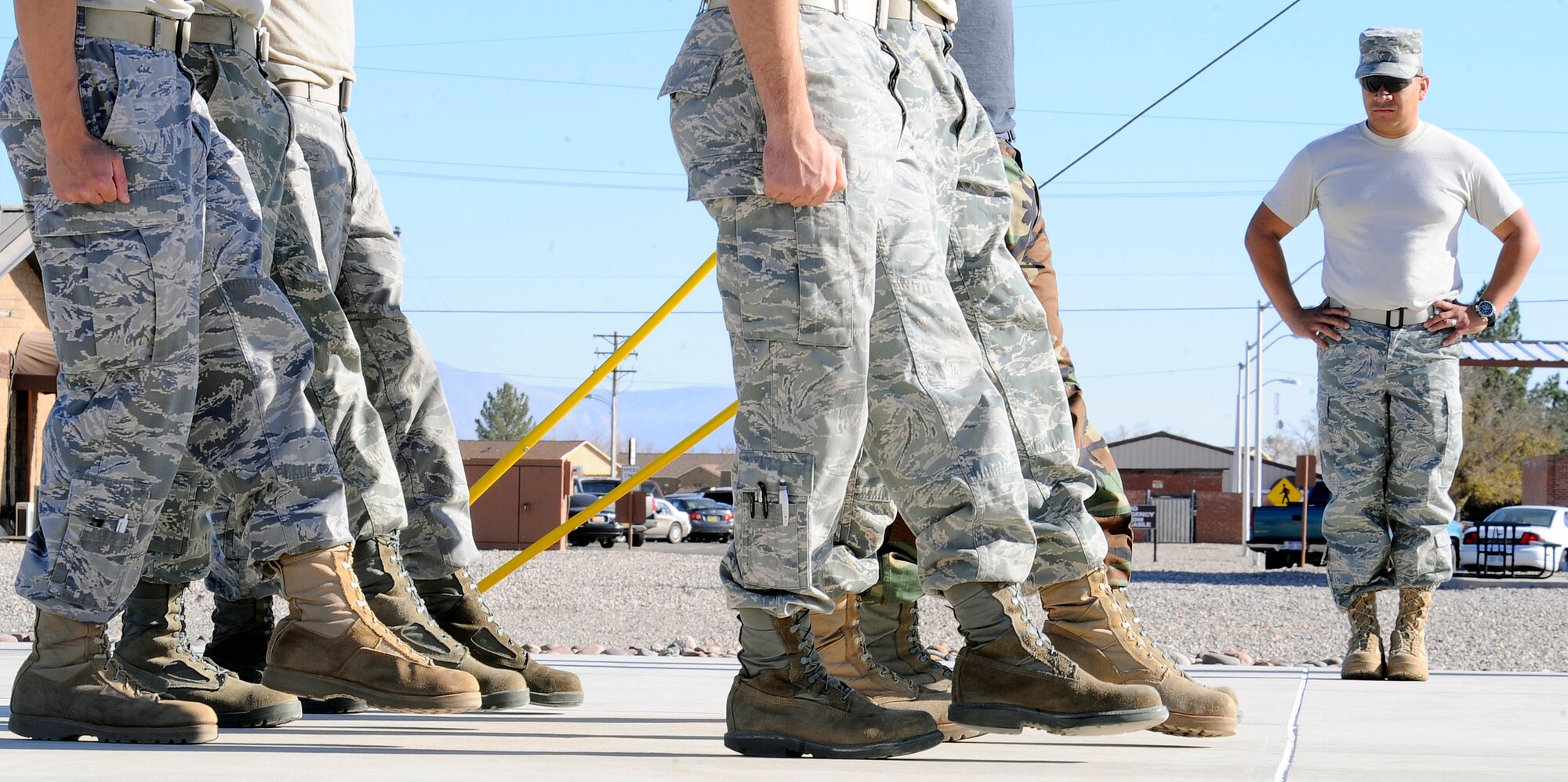 HOLLOMAN AIR FORCE BASE, N.M. -- Senior Airman Ernesto Farias, 49th Medical Support Squadron, observes members of Holloman's Steel Talon Honor Guard as they march in sequence here, Nov. 17. This marching is called a "hang step" and is performed during a funeral. (U.S. Air Force photo by Airman 1st Class Veronica Stamps)