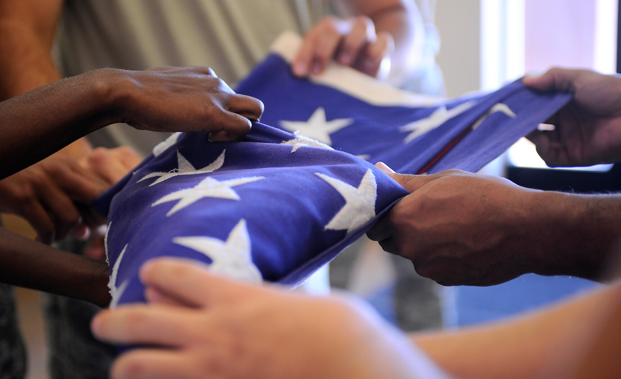 HOLLOMAN AIR FORCE BASE, N.M. -- Six members from Holloman's Steel Talon Honor Guard fold the U.S. Flag during their weekly practice here, Nov. 17. The Steel Talons perform six man folds and two man folds for military ceremonies. (U.S. Air Force photo by Airman 1st Class Veronica Stamps)