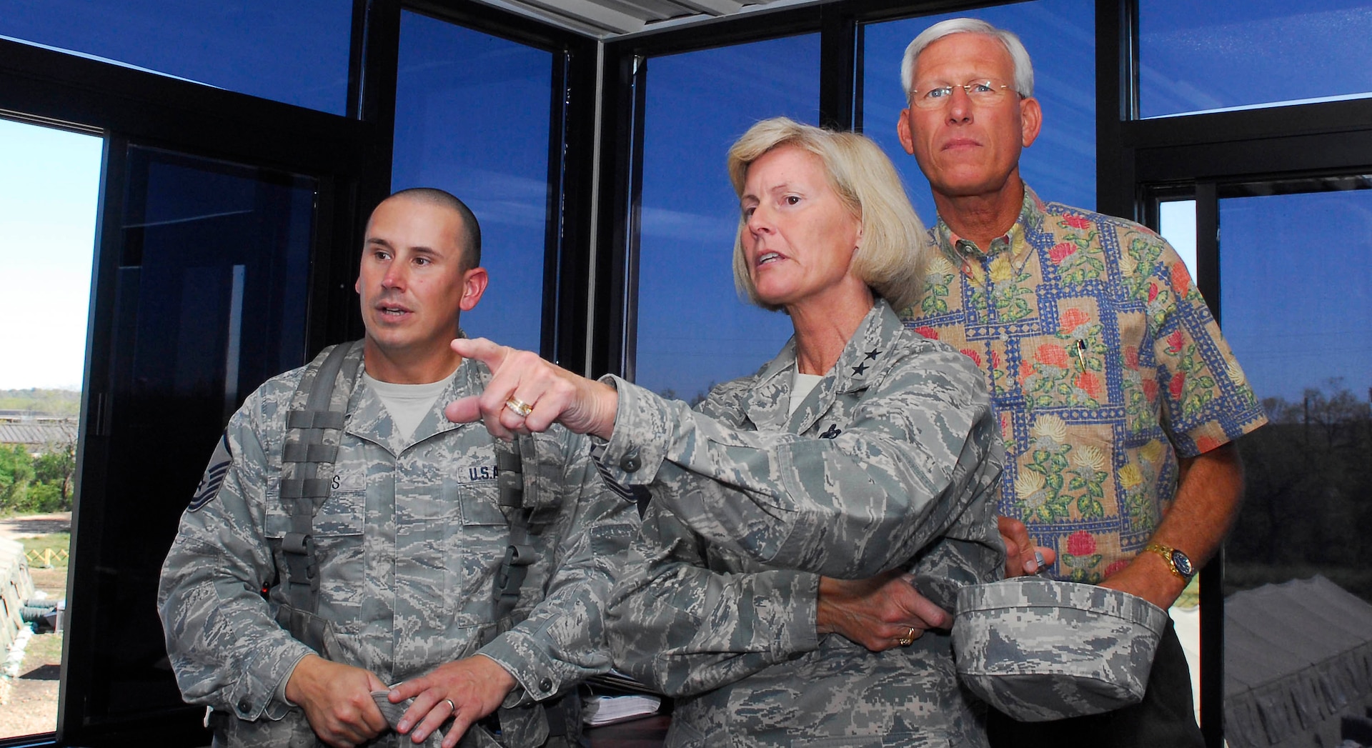 Maj. Gen. Mary Kay Hertog, 2nd Air Force commander, and her husband, retired Chief Master Sgt. Herm Hertog (right), view the Basic Expeditionary Airman Skills Training course from an observation tower on Lackland's Training Annex Nov. 17. The tour of the BEAST facilites, led by Master Sgt. James Woods, 319th Training Squadron (left), was part of the general's three-day orientation of the 37th Training Wing. (U.S. Air Force photo/Alan Boedeker)
