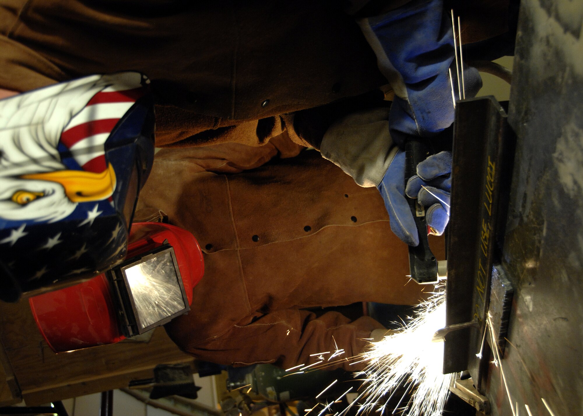 Staff Sgt. Dan Tiedemann observes as Brig. Gen. Guy Walsh cuts through a piece of steel using a plasma cutter here, Nov. 17. Plasma cutting is a small part of what the vehicle maintenance shop does on base, but is essential for certain jobs that come into the shop. Sergeant Tiedemann is the non-commissioned officer in charge of the vehicle management flight with the 451st Expeditionary Logistics Readiness Squadron from Wright-Patterson Air Force Base, Ohio, and General Walsh is the commander of the 451st Air Expeditionary Wing. (U.S. Air Force photo/Senior Airman Timothy Taylor)