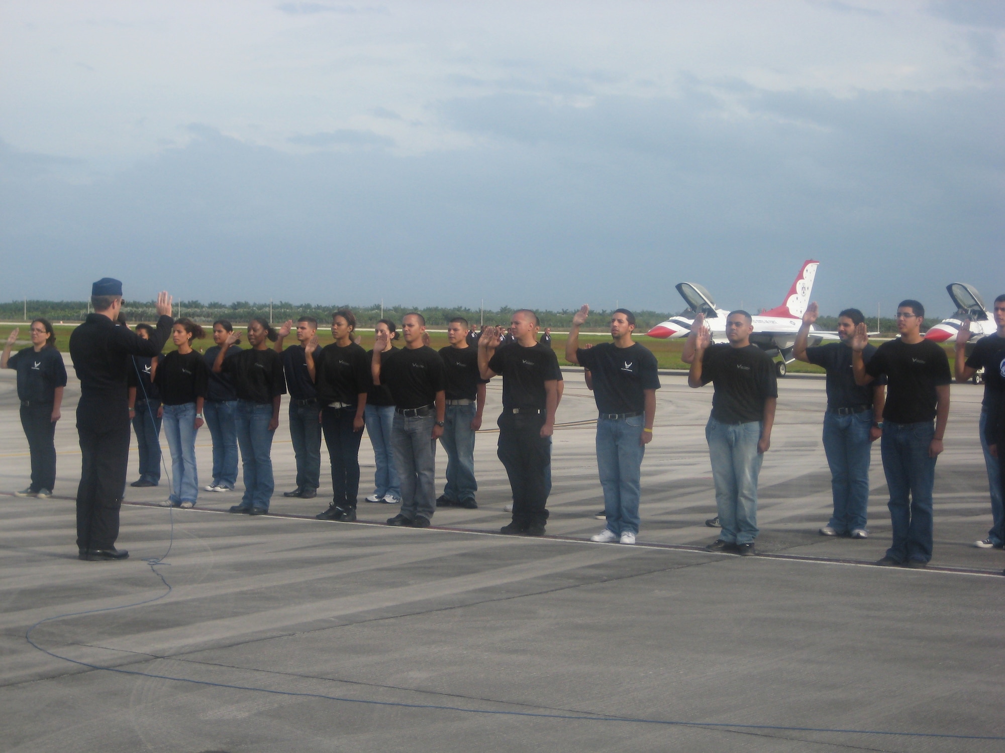 HOMESTEAD AIR FORCE BASE, Fla. -- Members of the Delayed Enlistment Program take the first step toward entering the Air Force at the 2009 Wings Over Homestead air show.
In front of the air show audience, the newest Airmen were sworn in by Lt. Col. Greg Thomas, Air Force Air Demonstration Squadron commander, who administered the oath of enlistment to the group of 30 new recruits, made up of Reserve and active-duty members. (U.S. Air Force photo)

