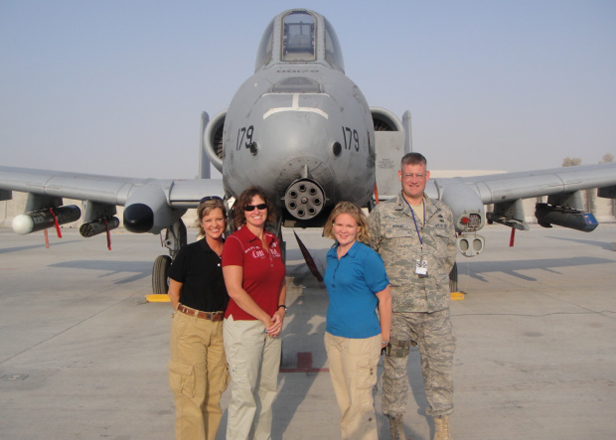 Auditors Amy Johnson, Pam Lewers, and Brittany Hargis, and the 451st Expeditionary Maintenance Group commander, Col. Robert Hopkins, stand in front of an A-10 Thunderbolt II on Kandahar Airfield. (Courtesy photo)