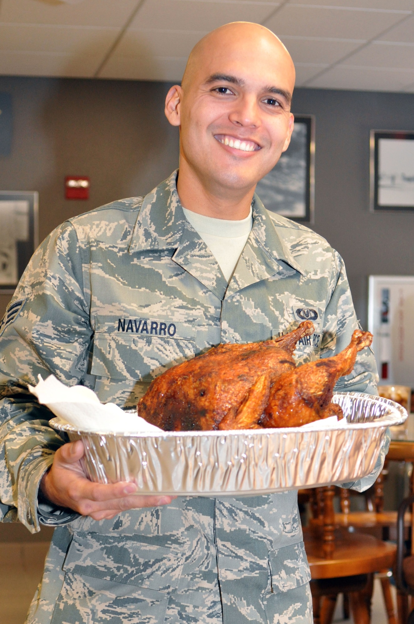 Senior Airmen Paul Navarro, an aircrew flight equipment technician new to the 917th operational support squadron at Barksdale Air Force Base, La., carries a Thanksgiving turkey into the 47th Fighter Squadron Heritage Room on Barksdale as he aids the preparations for the 47th FS Thanksgiving luncheon November 20, 2009. The 47th FS celebrated the holiday with an array of home cooked dishes provided by the military members and their families. (U.S. Air Force photo/Airman 1st Class Crystal Jordan)