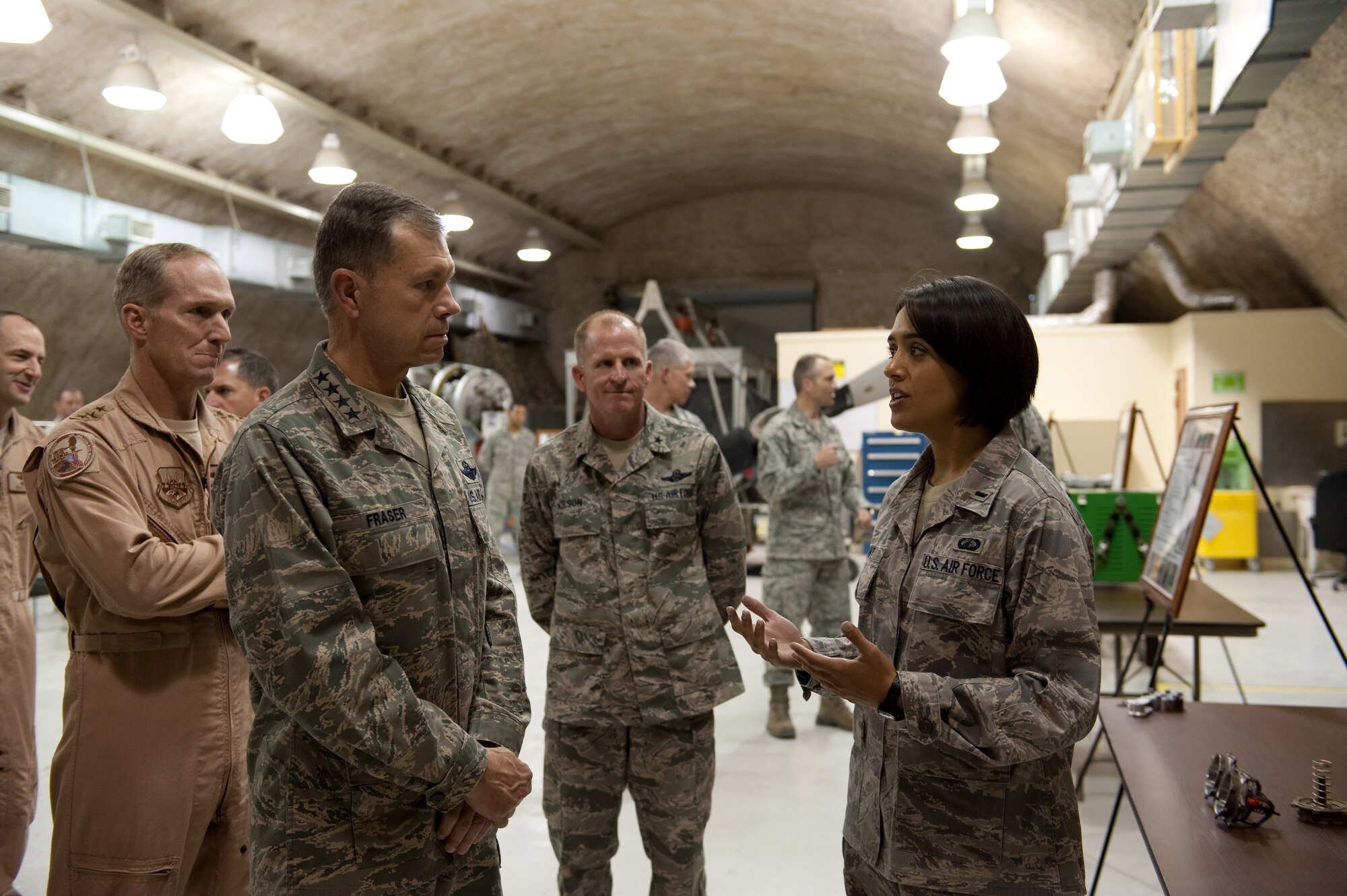 1st Lt. Rachel Grant, 379th Expeditionary Maintenance Operations Squadron, describes her role in designing and coordinating technical engineering assistance requests for a variety of aircraft to Commander of Air Combat Command, Gen. William Fraser, Nov. 22, 2009, in Southwest Asia. ACC senior leaders were visiting with deployed servicemembers as part of a U.S. Central Command area of responsibility tour. (U.S. Air Force photo/Staff Sgt. Robert Barney)