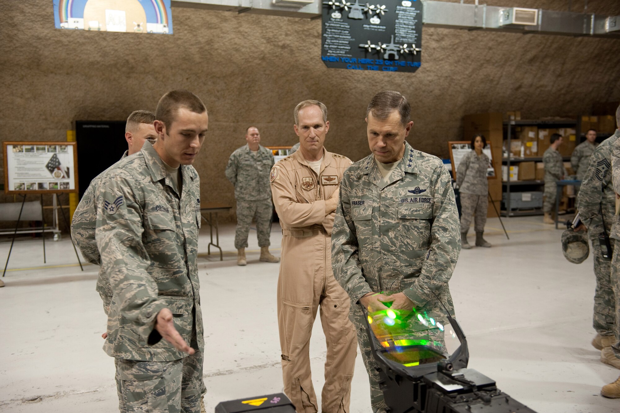 U.S. Air Force Staff Sgt. Allyn Robertson, 379th Expeditionary Medical Group bioenvironmental engineering flight, describes to Commander, Air Combat Command, Gen. William Fraser the role of the 379 EMDG BEE flight in support of base operations here, Nov. 22, 2009, in Southwest Asia. Gen. Fraser is on his first stop as he tours Air Combat Command personnel and resources throughout the U.S. Central Command area of responsibility. (U.S. Air Force photo/Staff Sgt. Robert Barney)