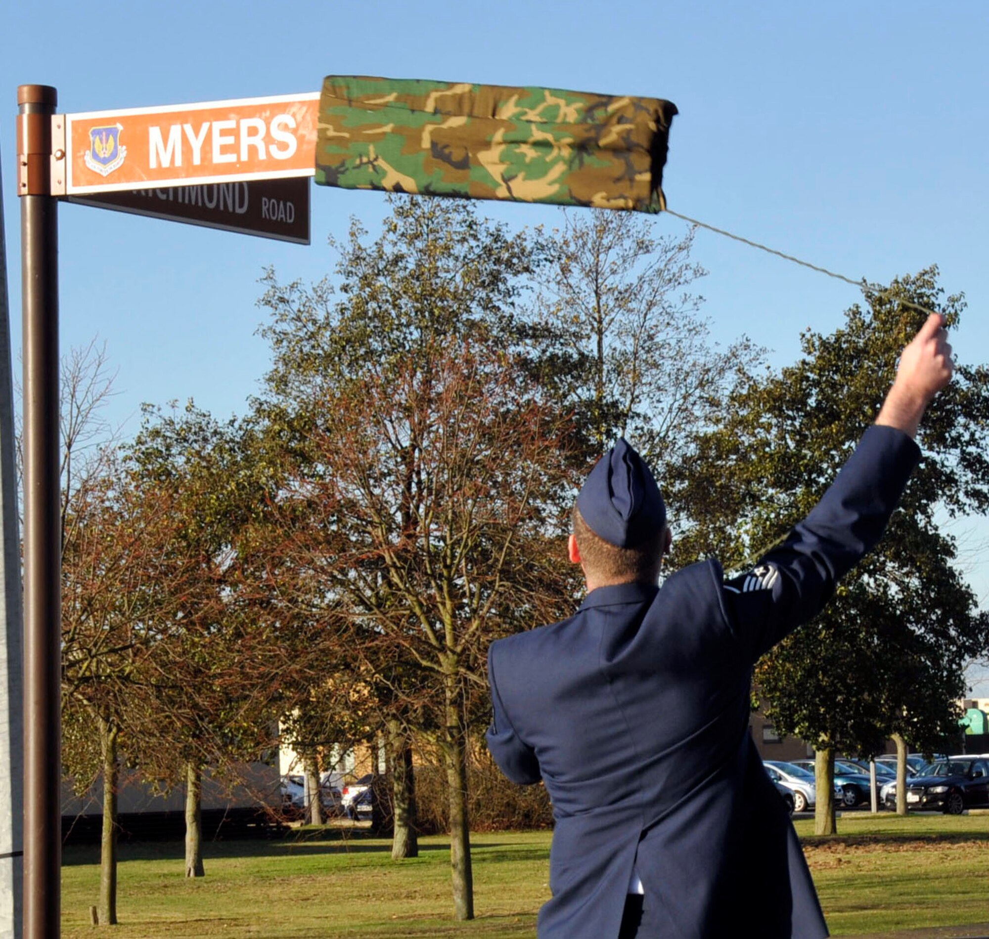Master Sgt. Hendrik Van De Pol, 48th Civil Engineer Squadron Explosive Ordnance Disposal flight chief, unveils the Myers Way street sign during the dedication ceremony Nov. 23. Airmen from the 48th Fighter Wing gathered to pay tribute, dedicate and rename a portion of road on RAF Lakenheath in the memory of Tech. Sgt. Phillip Myers. Sergeant Myers, a 48th CES EOD technician, was killed as result of an improvised explosive device attack while deployed to Afghanistan on April 4, 2009.