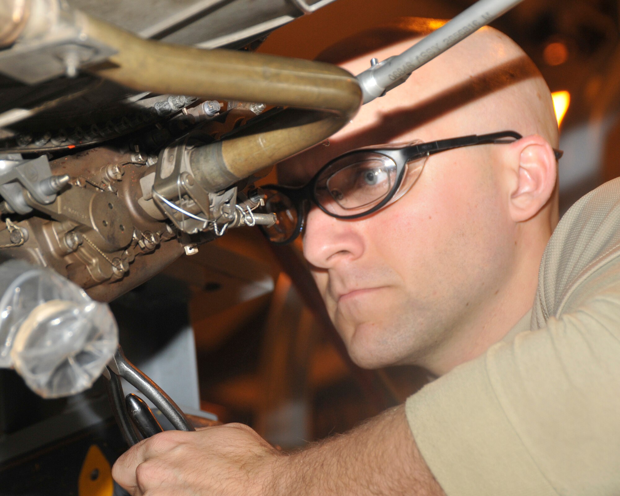 Staff Sgt. John Stephenson, 48th Component Maintenance Squadron aerospace propulsion craftsman, repairs safety wires found while inspecting the jet engine on RAF Lakenheath, England, Nov. 16. Safety wires come in two different sizes to provide stability and helps minimize engine vibration during the flight. (U.S. Air Force photo by Airman 1st Class Eboni Knox)