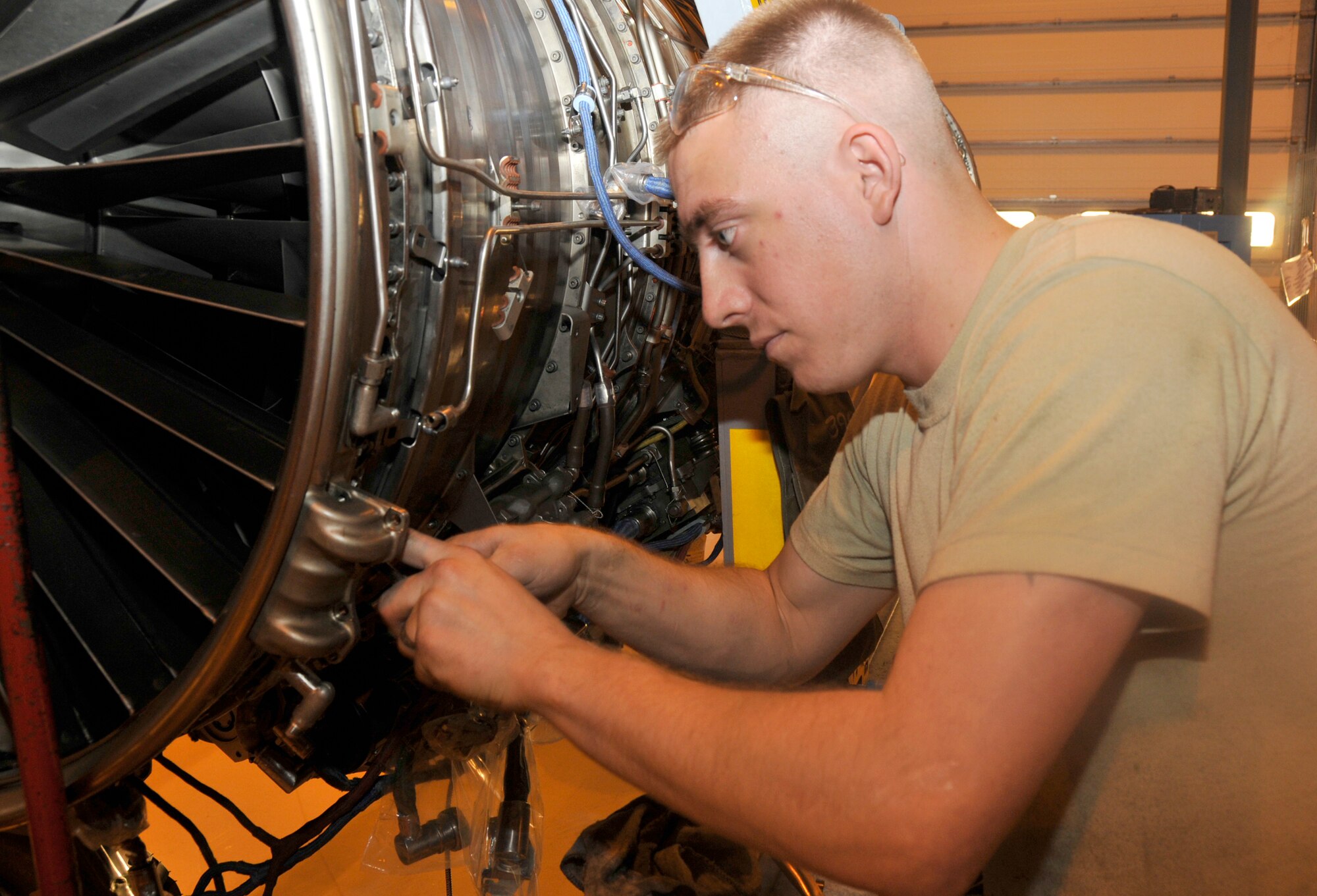 Senior Airman Jake Garcia, 48th Component Maintenance Squadron aerospace propulsion journeyman, reinstalls an inlet fan case on a jet engine at RAF Lakenheath, England, Nov. 16. The inlet fan case helps to direct air flow into the engine to help keep it cooled. (U.S. Air Force photo by Airman 1st Class Eboni Knox)