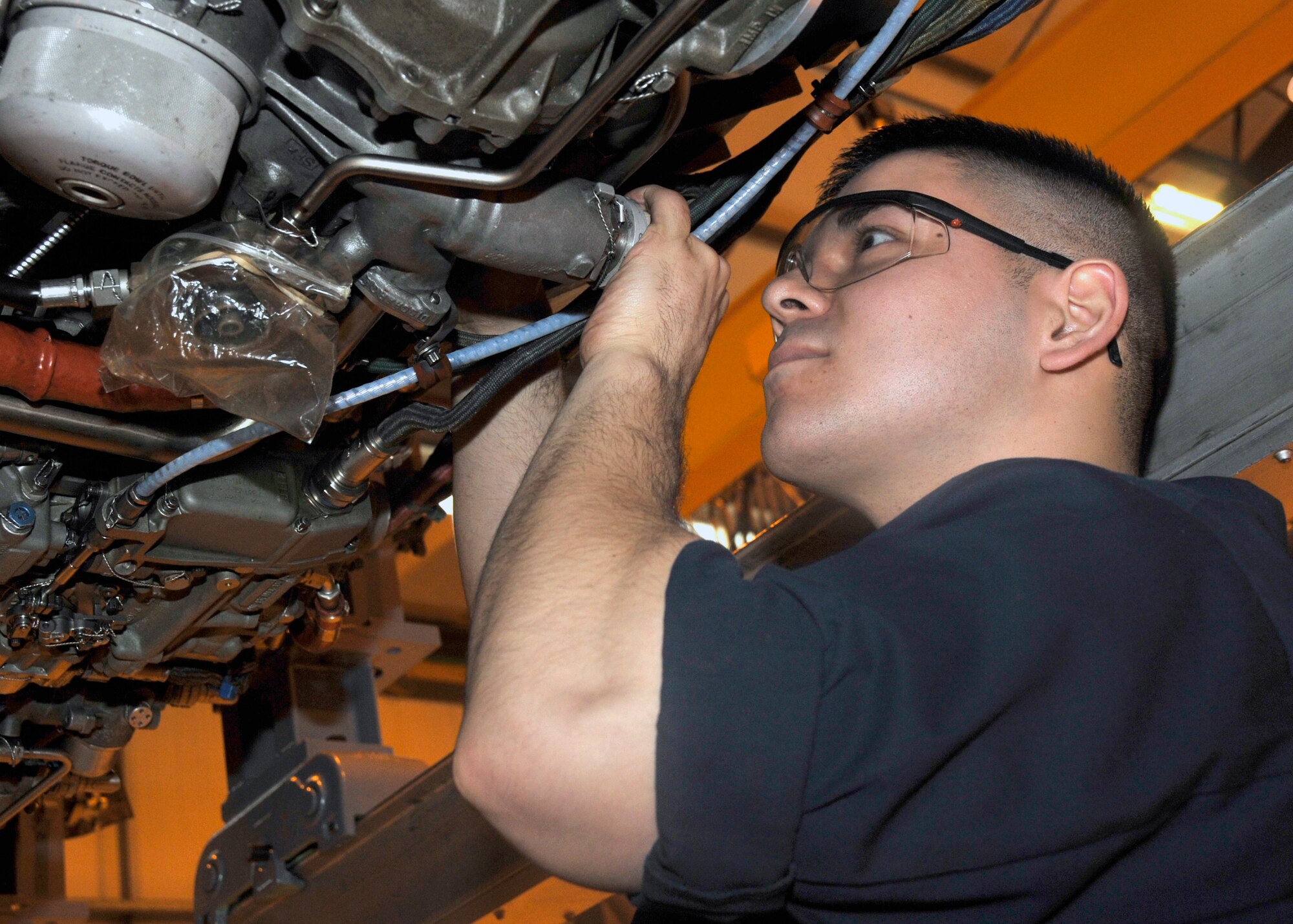 Airman 1st Class Jeremy Sauceda, 48th Component Maintenance Squadron aerospace propulsion journeyman, tightens and repairs safety wires on a jet engine at the “prop shop” on RAF Lakenheath, England, Nov. 16. Safety Wires are used to reduce vibration during flight to insure fire and explosion safety. (U.S. Air Force photo by Airman 1st Class Eboni Knox)