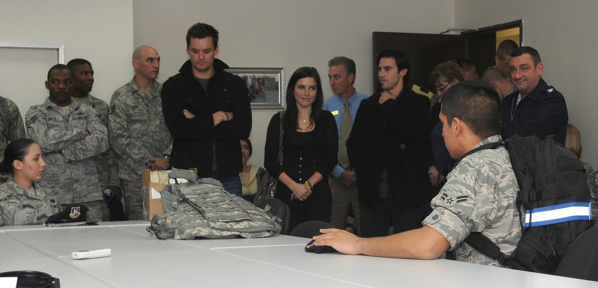 Celebrity guests Austin Nichols and Sophia Bush, from the television show One Tree Hill, and Milo Ventimiglia, from the television show Heroes, visit Incirlik’s law enforcement desk to show their appreciation to the Airmen of the 39th Security Forces Squadron for their military service, Monday, Nov. 23, 2009.  The three TV stars are visiting Incirlik as part of the celebrity handshake tour sponsored by United Service Organizations.  (U.S. Air Force photo/Senior Airman Ashley Wood)