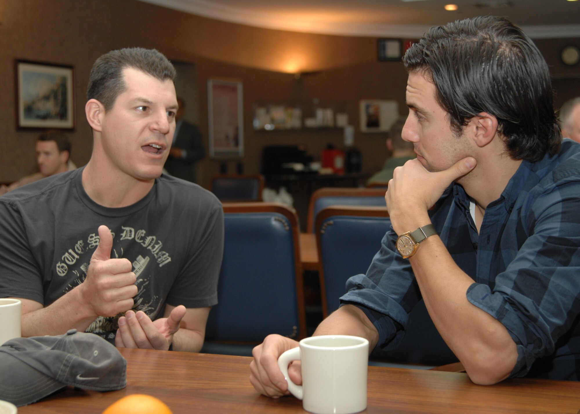 Lt. Col. Matthew Mrzenc, 385th Expeditionary Airlift Refueling Squadron , explains his job as a KC-135 pilot to Milo Ventimiglia, of the television show Heroes, during breakfast at the dining facility Monday, Nov. 23, 2009, at Incirlik Air Base, Turkey. Mr.Ventimiglia, Sophia Bush and Austin Nichols both of  the television show One Tree Hill, visited the base as part of a United Service Organization celebrity handshake tour. (U.S. Air Force photo/Staff Sgt. Lauren Padden)