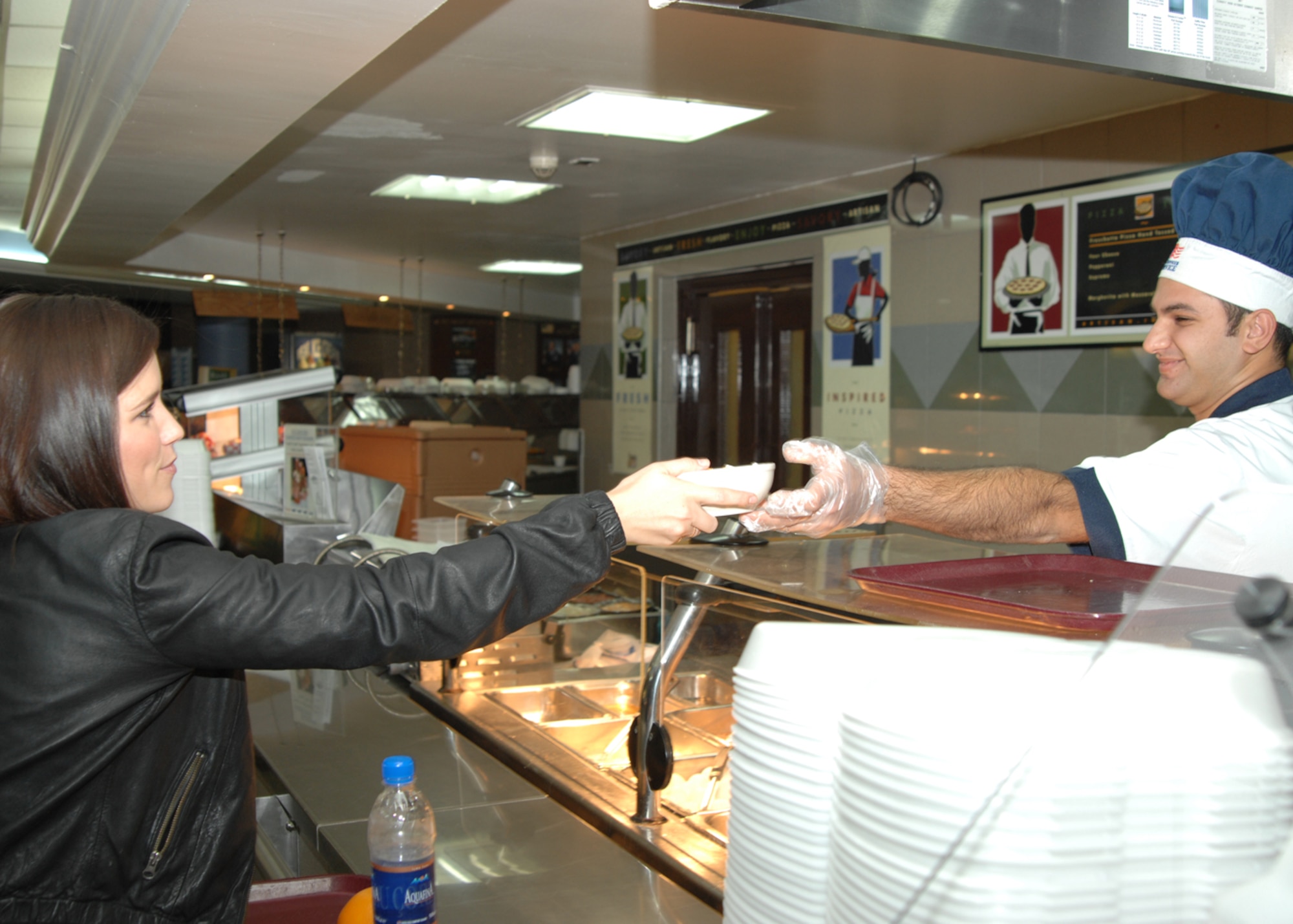 Sophia Bush, of the TV show One Tree Hill receives her food from Serkan Keskin, 39th Force Support Squadron at the dining facility Monday, Nov. 23, 2009, at Incirlik Air Base, Turkey. Ms. Bush, Austin Nichols, of the television show One Tree Hill and Milo Ventimiglia, of the television show Heroes visited the base as part of a United Service Organizations celebrity handshake tour. (U.S. Air Force photo/Staff Sgt. Lauren Padden)