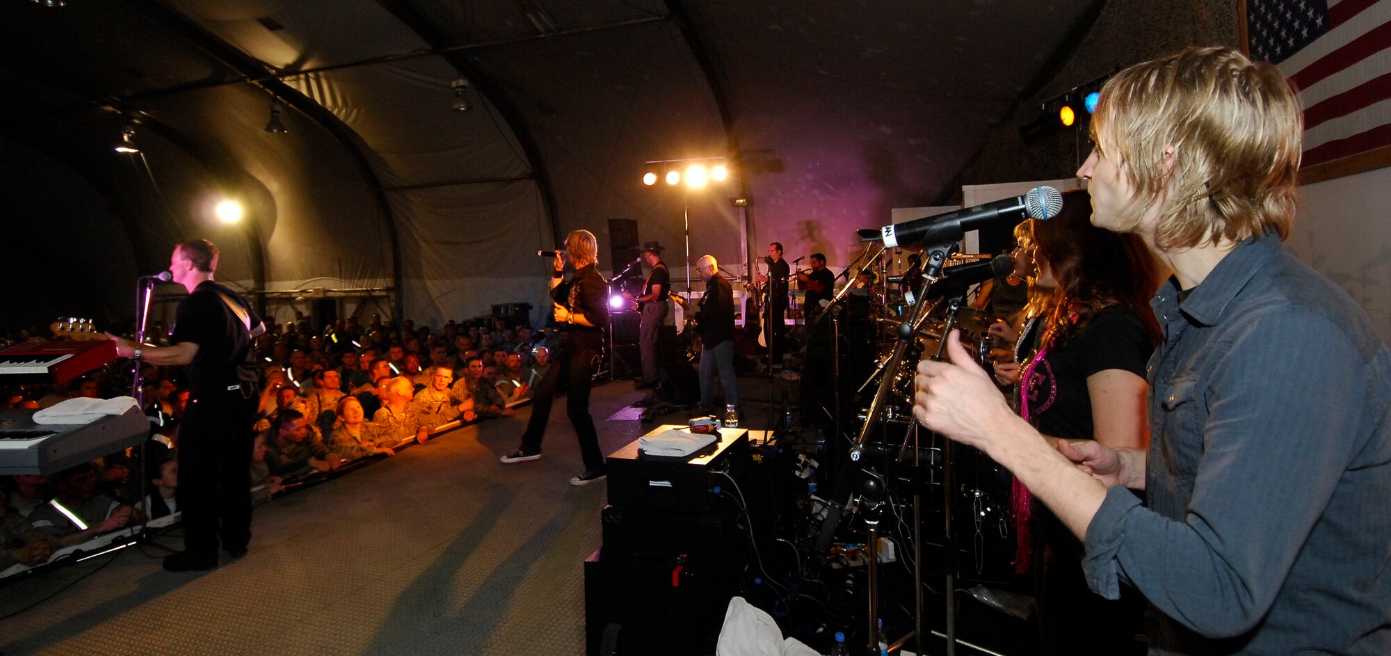BAGRAM AIRFIELD, Afghanistan -- Gary Sinise and Kimo Williams met in 1997 while working together on a play called "A Streetcar Named Desire," in Chicago. They continued to meet and have jam sessions on the guitar and bass, gradually adding other musicians. The Lt. Dan Band did their first USO tour in 2004, visiting Korea, Singapore and Diego Garcia - since then they average 30-40 shows a year, with 75% of the profits going towards the USO and other charities. The band name was chosen because Mr. Sinise was constantly recognized by a character he played in the movie "Forrest Gump" called Lt. Dan. (U.S. Air Force photo/ Senior Airman Susan Tracy)
