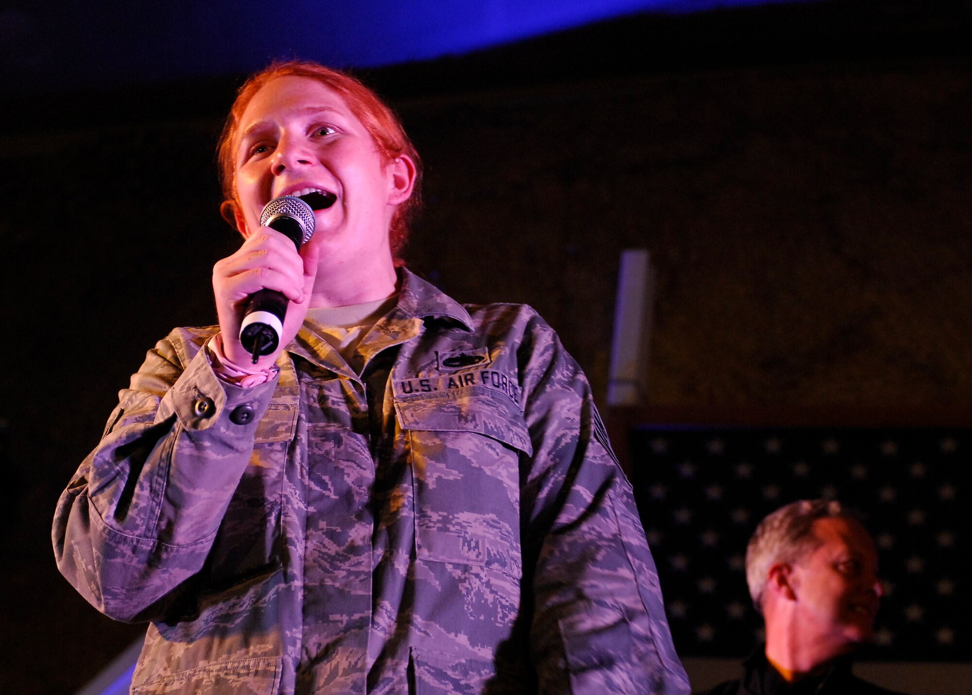 BAGRAM AIRFIELD, Afghanistan -- Tech. Sergeant Amanda Burns, a Falmouth, Ken., native deployed from the U.S. Air Force Academy, sings the Air Force song during a concert hosted by
the USO, 23 Nov., 2009. Sergeant Burns won a pair of round trip tickets in the U.S.  from American Airlines. (U.S. Air Force photo/ Senior Airman Susan Tracy)