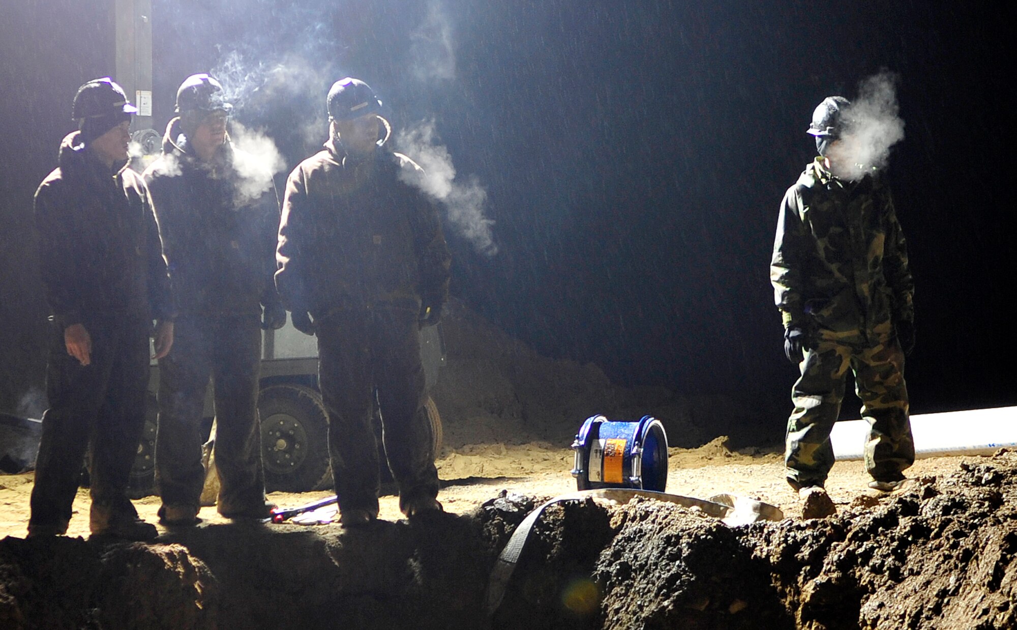 Airmen from the 51st Civil Engineer Squadron prepare to replace sections of a 12-inch and an eight-inch water main that ruptured at Osan Air Base, Republic of Korea, Nov. 20. The pipes broke due to an underground slippage of concrete that was used to cover a pre-existing benjo ditch near the pipes. Airmen and civilians from agencies across Osan worked together for more than 24 hours to repair the broken water mains. 
(U.S. Air Force photo/Staff Sgt. Brian Ferguson)


