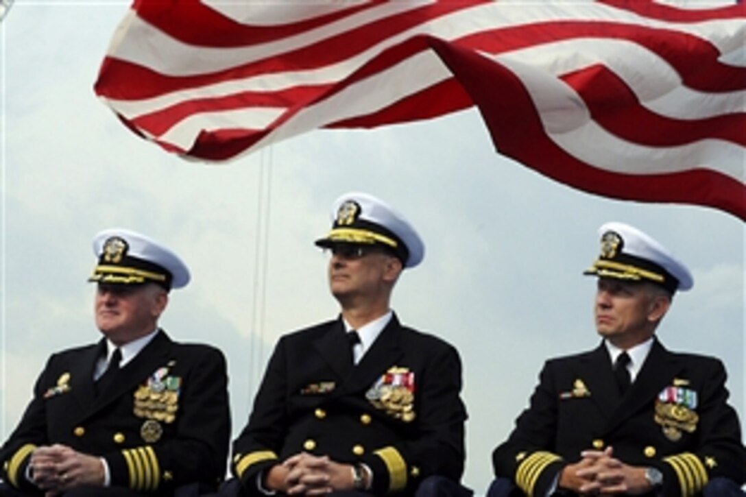 U.S. Capt. Rudy Lupton, prospective commanding officer of the U.S. 7th Fleet command ship USS Blue Ridge; Rear Adm. Richard B. Landolt, commander of Amphibious Force U.S. 7th Fleet; and Capt. Thom W. Burke, outgoing commanding officer of the Blue Ridge, listen to remarks from Vice Adm. John M. Bird, commander of the U.S. 7th Fleet, during the Blue Ridge change of command ceremony, Yolosuka, Japan, Nov. 24, 2009.
