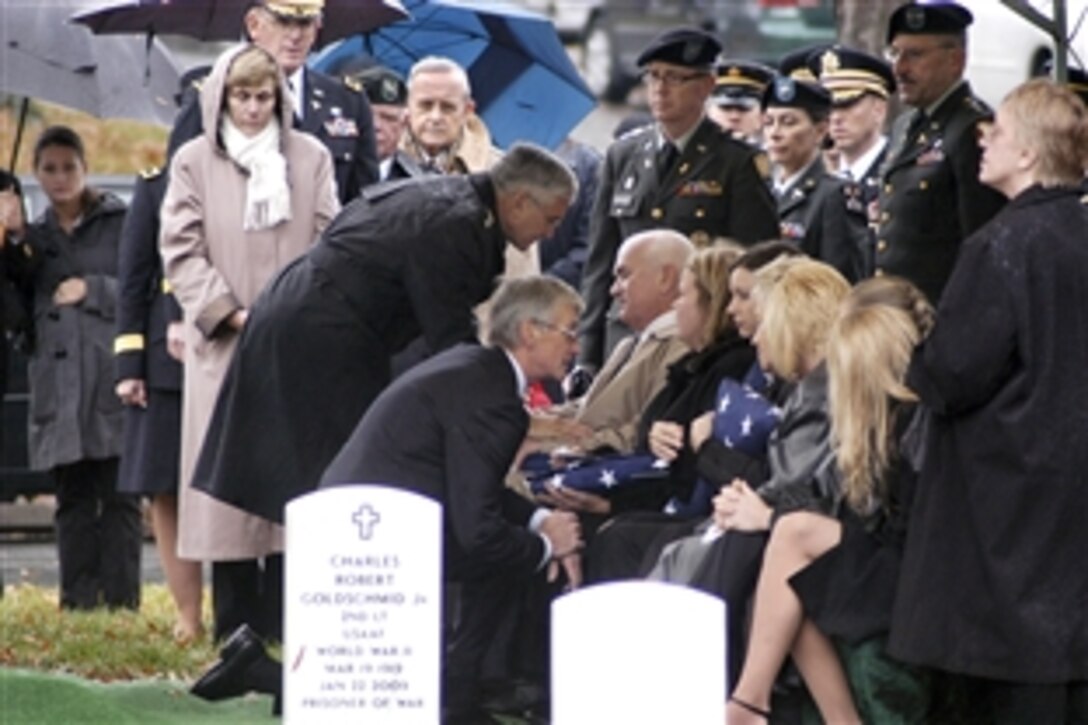 Army Secretary John M. McHugh and Army Chief of Staff Gen. George W. Casey Jr. console the family members of Lt. Col. Juanita Warman during a memorial service at Arlington National Cemetery, Nov. 23, 2009. Warman, who was at Fort Hood preparing for a late-November deployment, was the highest-ranking soldier killed during the shooting rampage on Fort Hood, Texas.