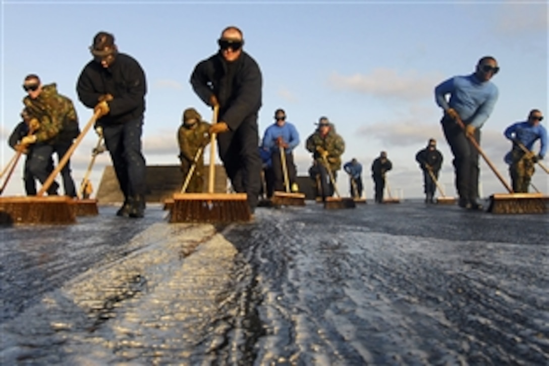 U.S. sailors scrub down the flight deck of the aircraft carrier USS John C. Stennis in the Pacific Ocean, Nov. 20, 2009. The Stennis is returning to homeport in San Diego after completing a sustainment exercise off the coast of Southern California.