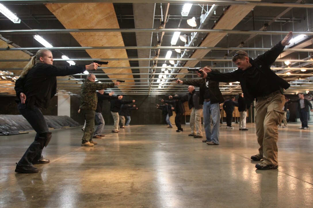Marines practice drawing their pistols at a moment’s notice during a V.I.P. security course at the Indoor Small-Arms Range Nov. 24. For three days, Marines from Marine Corps Air Station Iwakuni, Japan, trained with former members of the Israeli Special Forces in tactics used in V.I.P. protection.