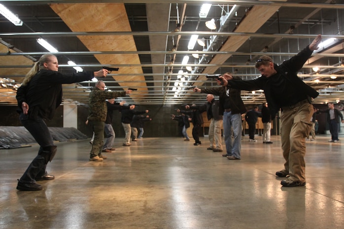 Marines practice drawing their pistols at a moment’s notice during a V.I.P. security course at the Indoor Small-Arms Range Nov. 24. For three days, Marines from Marine Corps Air Station Iwakuni, Japan, trained with former members of the Israeli Special Forces in tactics used in V.I.P. protection.