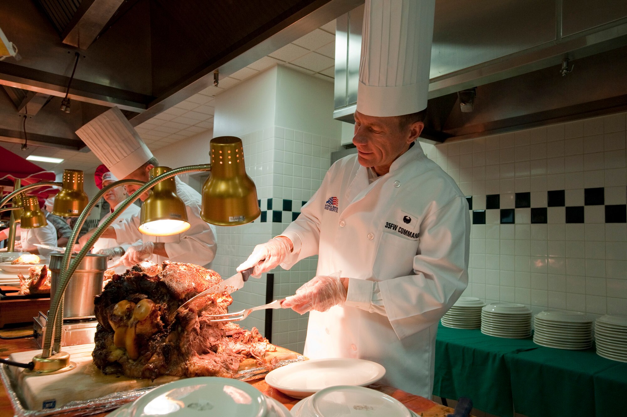 MISAWA AIR BASE, Japan -- Col. David Stilwell, 35th Fighter Wing commander, carves roast beef at the Grissom Dining Facility on Thanksgiving, Nov. 26. Wing leadership were at the dining facility to serve the annual Thanksgiving meal to the Misawa Air Base service members. (U.S. Air Force photo/Staff Sgt. Samuel Morse)