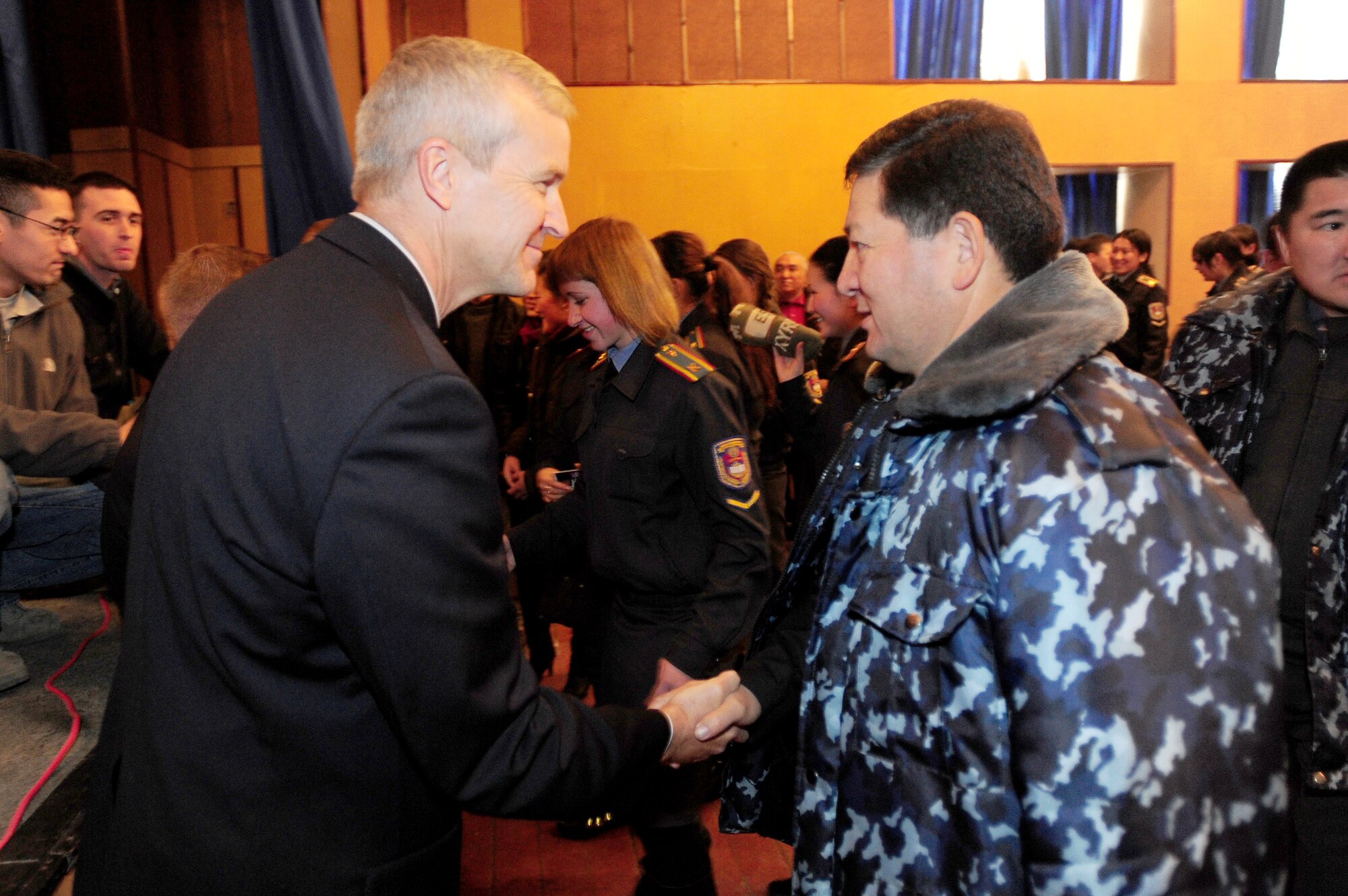 BISHKEK, Kyrgyzstan -- Lt. Col. Larry Lang, U.S. Air Forces Central Band director, is thanked by leadership at the Academy for the Ministry of Internal Affairs following a performance by Sirocco, Nov. 18, 2009. (U.S. Air Force photo/Senior Airman Steele C. G. Britton)