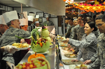 SOTO CANO AIR BASE, Honduras -- Gen. Douglas Fraser, Commander, U.S. Southern Command, serves stuffing to Airman 1st Class Kristen Olson, Medical Element emergency medical technician, during a Thanksgiving meal here Nov. 25. General Fraser visited the men and women of JTF-Bravo to thank them for their hard work, particularly in the recent El Salvador disaster relief mission, and wish them all a happy Thanksgiving holiday. (U.S. Air Force photo by Staff Sgt. Chad Thompson)