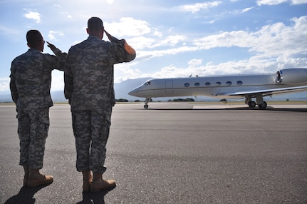 SOTO CANO AIR BASE, Honduras -- Command Sgt. Maj. Eloy Alcivar, Joint Task Force-Bravo command sergeant major, and Col. Chris Gehler, JTF-Bravo commander, salute as Gen. Douglas Fraser, Commander, U.S. Southern Command, departs after visiting here Nov. 25. General Fraser spoke to the Soldiers, Sailors and Airmen here, helped serve them a Thanksgiving meal and wished all JTF-Bravo members a happy Thanksgiving holiday. (U.S. Air Force photo by Staff Sgt. Chad Thompson)