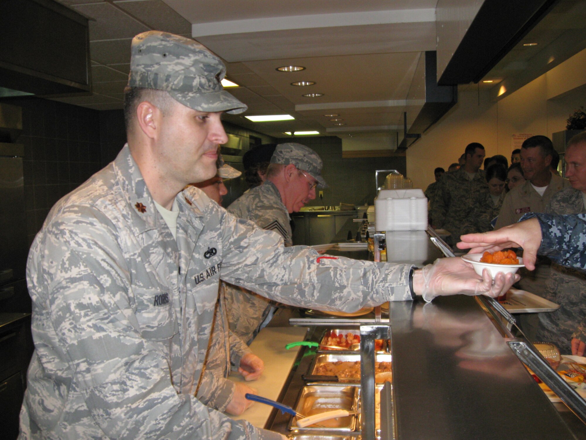 Maj. Rick Rogers, 931st Aircraft Maintenance Squadron commander, serves a bowl of carrots to a U.S. Navy Reservist at McConnell Air Force Base, Kan., on Nov. 14. Members of the 931st Air Refueling Group's senior leadership served lunch at the base dining facility during the 931st's November weekend drill as a way to show  gratitude for the dedication of their Airmen this holiday season. (U.S. Air Force photo/Tech. Sgt. Celeste Lindquist)
